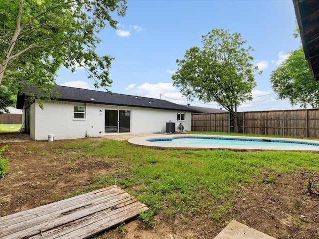 1013 Nueva Tierra St, Grand Prairie, TX 75052 - rear view of house featuring a fenced backyard, central AC unit, and brick siding