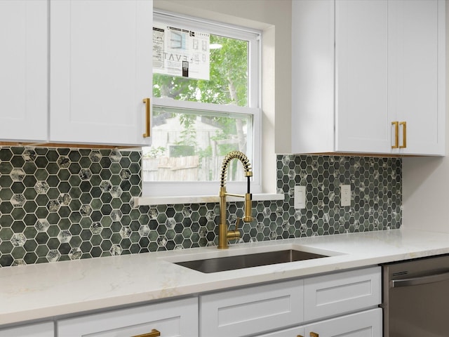 1013 Nueva Tierra St, Grand Prairie, TX 75052 - kitchen with stainless steel dishwasher, a sink, white cabinets, and decorative backsplash