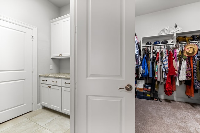 1020 Highpoint Way, Roanoke, TX 76262 - walk in closet with light tile patterned flooring and light colored carpet