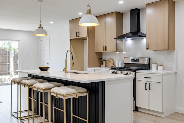 4128 Blackwillow Dr, Mesquite, TX 75150 - kitchen featuring wall chimney exhaust hood, stainless steel range with gas stovetop, a sink, tasteful backsplash, and a kitchen island with sink