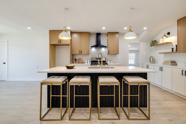 4128 Blackwillow Dr, Mesquite, TX 75150 - kitchen featuring wall chimney range hood, a sink, light countertops, open shelves, and a breakfast bar