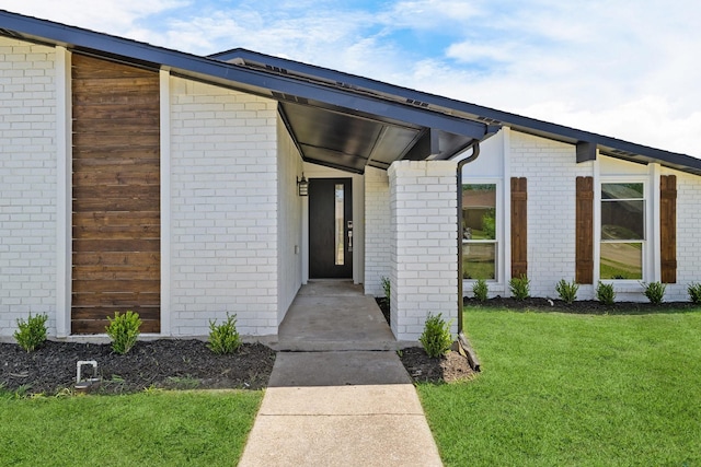 4128 Blackwillow Dr, Mesquite, TX 75150 - view of exterior entry featuring a lawn and brick siding