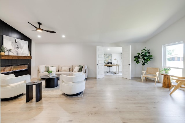 4128 Blackwillow Dr, Mesquite, TX 75150 - living room featuring lofted ceiling, light wood-style floors, ceiling fan, a large fireplace, and baseboards