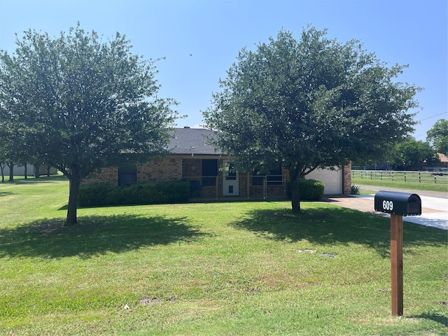 609 S 3rd St, Sanger, TX 76266 - obstructed view of property with a garage, driveway, and brick siding