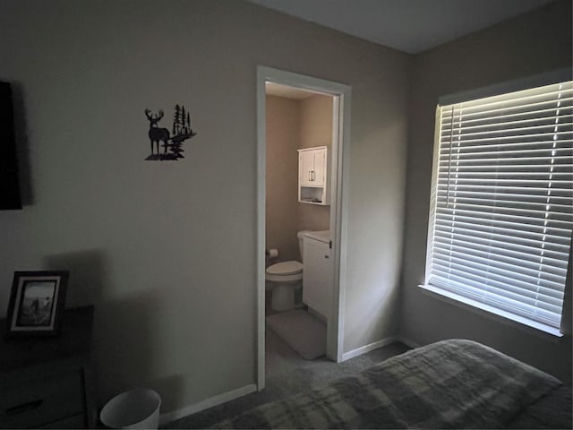 609 S 3rd St, Sanger, TX 76266 - carpeted bedroom with baseboards and ensuite bathroom