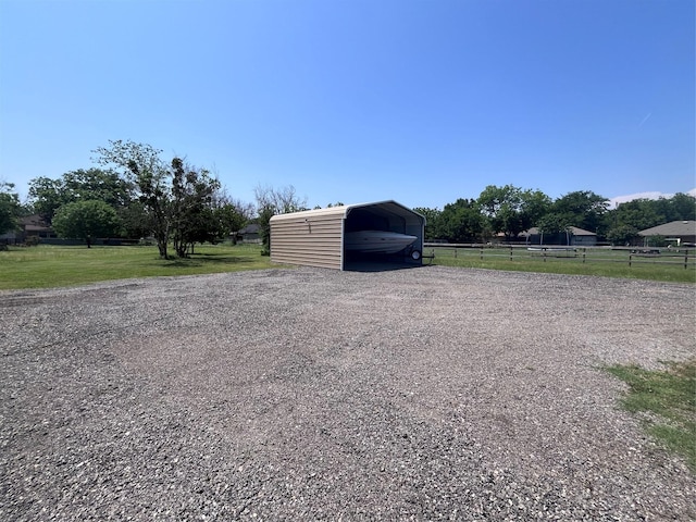 609 S 3rd St, Sanger, TX 76266 - view of outbuilding featuring a carport and gravel driveway