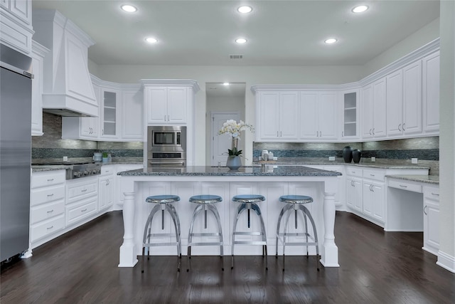 1070 Great Meadow Dr, Allen, TX 75013 - kitchen with built in appliances, backsplash, white cabinets, a breakfast bar area, and recessed lighting