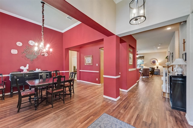 1522 Farm Dl, Allen, TX 75002 - dining space featuring a chandelier, a towering ceiling, wood finished floors, and baseboards