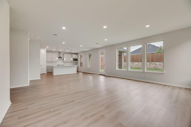 3229 Loftwood Ln, Anna, TX 75409 - unfurnished living room featuring light wood-style floors and recessed lighting