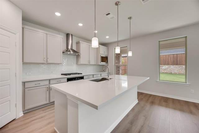 3229 Loftwood Ln, Anna, TX 75409 - kitchen featuring wall chimney range hood, light wood-style floors, light countertops, and recessed lighting