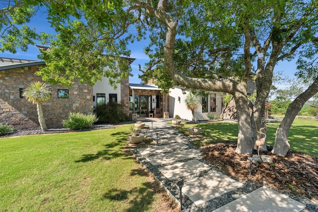 2333 County Road 163, Stephenville, TX 76401 - view of front of house with a standing seam roof, a front yard, stone siding, and metal roof