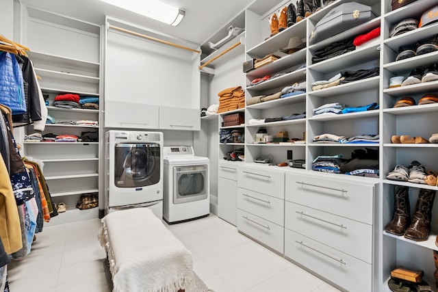 2333 County Road 163, Stephenville, TX 76401 - washroom featuring washer and clothes dryer, cabinet space, and light tile patterned floors