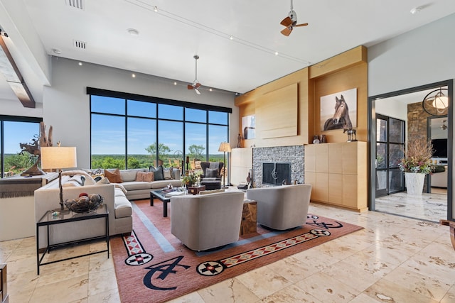 2333 County Road 163, Stephenville, TX 76401 - living area featuring a tile fireplace, a ceiling fan, and a high ceiling