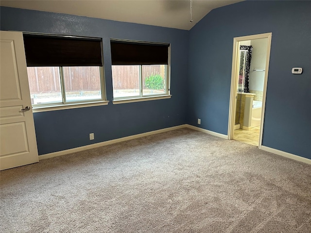 409 Hoover Ave, Lavon, TX 75166 - unfurnished bedroom with lofted ceiling, carpet floors, and ensuite bathroom