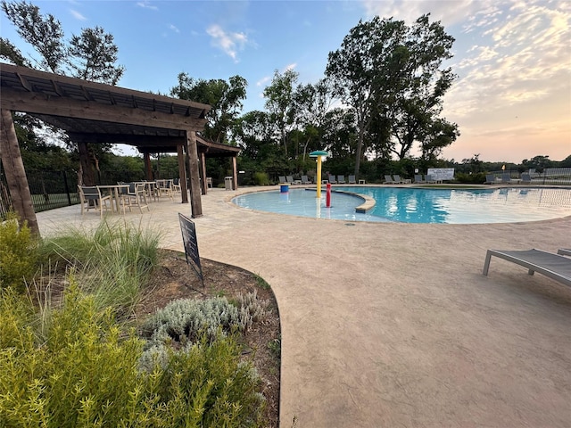 409 Hoover Ave, Lavon, TX 75166 - pool at dusk featuring a community pool and a patio
