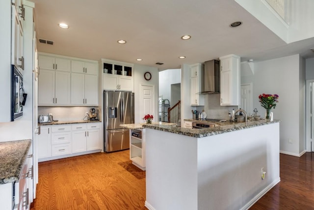 431 Lakefield Dr, Murphy, TX 75094 - kitchen featuring stainless steel fridge with ice dispenser, wall chimney exhaust hood, tasteful backsplash, light wood-type flooring, and recessed lighting