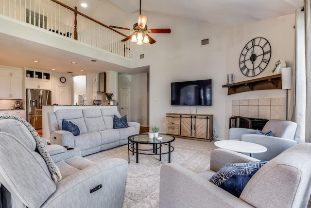 431 Lakefield Dr, Murphy, TX 75094 - living room with ceiling fan, a high ceiling, a tile fireplace, recessed lighting, and baseboards