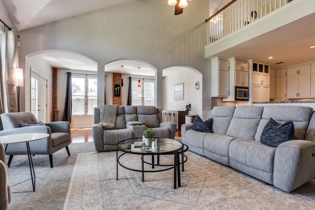 431 Lakefield Dr, Murphy, TX 75094 - living area with arched walkways, a towering ceiling, ceiling fan, and recessed lighting