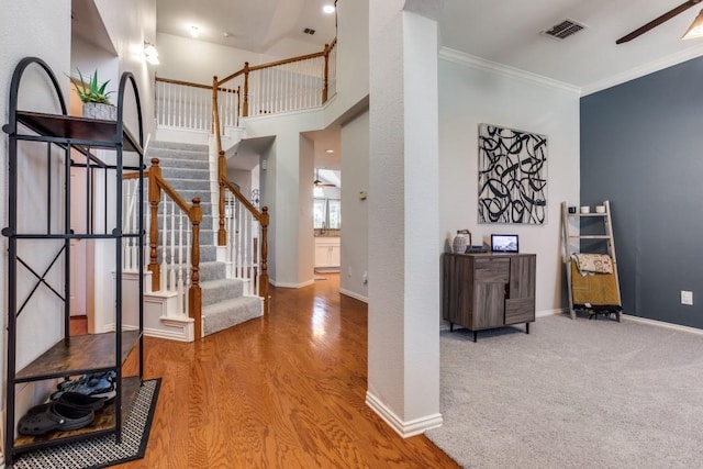 431 Lakefield Dr, Murphy, TX 75094 - entryway with a ceiling fan, stairs, ornamental molding, wood finished floors, and baseboards