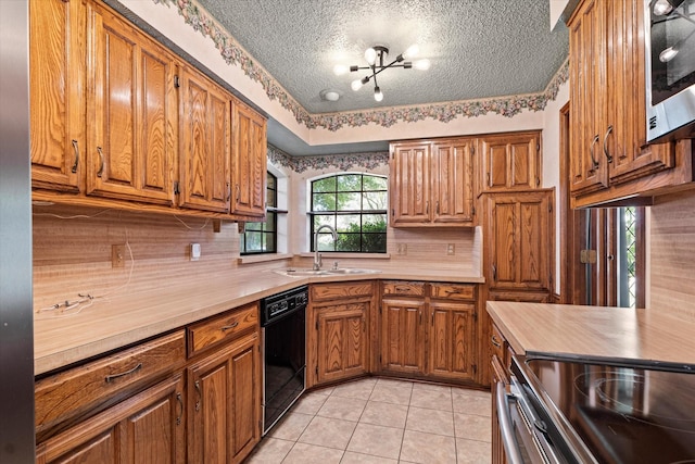 4001 Sonora Dr, Plano, TX 75074 - kitchen featuring black dishwasher, light countertops, brown cabinetry, and a textured ceiling