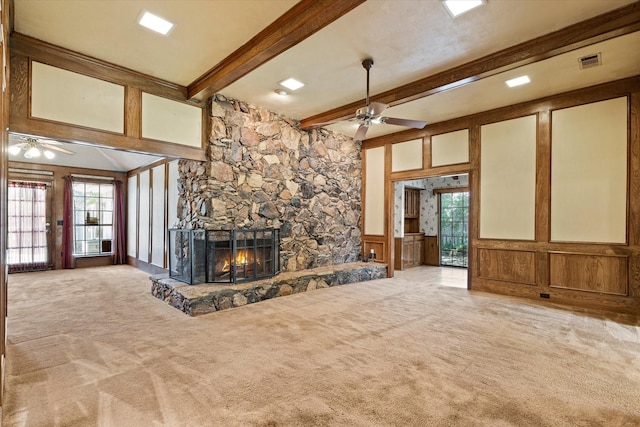 4001 Sonora Dr, Plano, TX 75074 - unfurnished living room featuring a ceiling fan, a decorative wall, carpet, a fireplace, and beamed ceiling