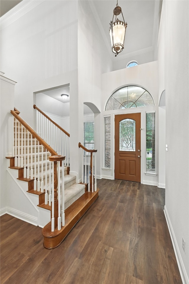 3816 Appleton Ln, Flower Mound, TX 75022 - entrance foyer featuring a towering ceiling, wood finished floors, stairs, arched walkways, and a chandelier