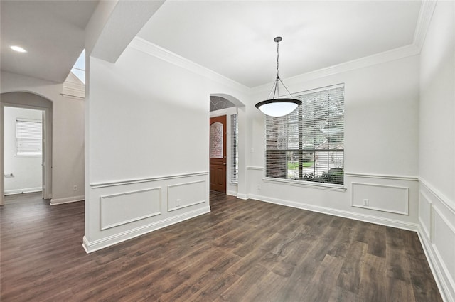 3816 Appleton Ln, Flower Mound, TX 75022 - unfurnished dining area featuring arched walkways, ornamental molding, dark wood-type flooring, a wainscoted wall, and a decorative wall