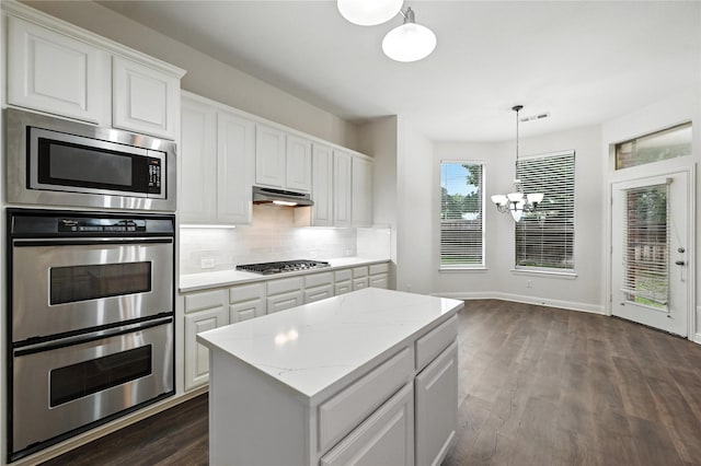 3816 Appleton Ln, Flower Mound, TX 75022 - kitchen featuring stainless steel appliances, a chandelier, decorative backsplash, white cabinets, and dark wood-style floors