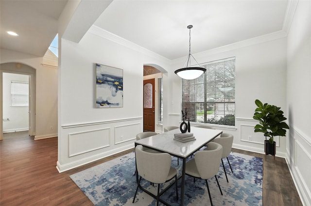 3816 Appleton Ln, Flower Mound, TX 75022 - dining space featuring arched walkways, crown molding, dark wood-style floors, a decorative wall, and a wainscoted wall
