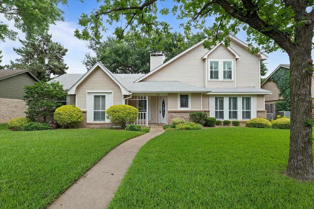 132 Cherrybark Dr, Coppell, TX 75019 - traditional-style house featuring brick siding, a front yard, a chimney, and covered porch