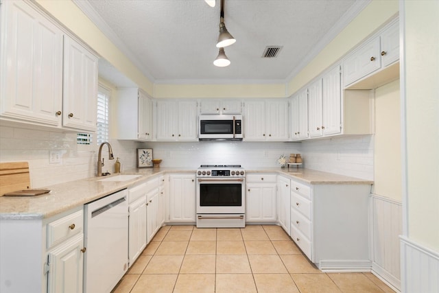 132 Cherrybark Dr, Coppell, TX 75019 - kitchen featuring white appliances, a sink, tasteful backsplash, light tile patterned floors, and white cabinets