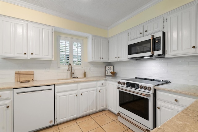 132 Cherrybark Dr, Coppell, TX 75019 - kitchen featuring white appliances, a sink, crown molding, backsplash, and white cabinetry