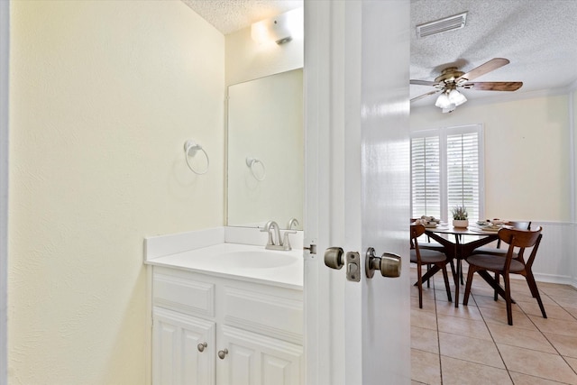 132 Cherrybark Dr, Coppell, TX 75019 - bathroom with a textured ceiling, tile patterned flooring, ceiling fan, and vanity