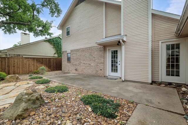 132 Cherrybark Dr, Coppell, TX 75019 - back of house featuring brick siding and a patio area