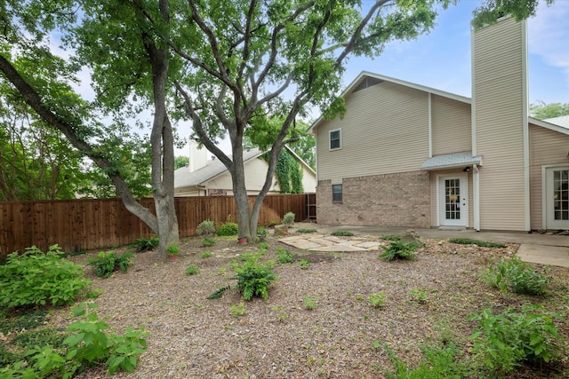 132 Cherrybark Dr, Coppell, TX 75019 - rear view of house with brick siding, a chimney, and a patio area