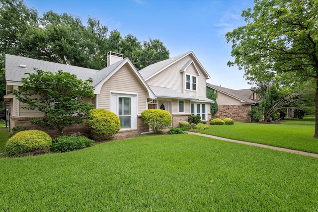 132 Cherrybark Dr, Coppell, TX 75019 - traditional home featuring brick siding, a chimney, and a front yard