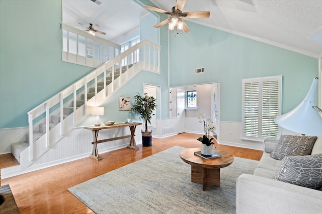 132 Cherrybark Dr, Coppell, TX 75019 - living room with a ceiling fan, healthy amount of natural light, wainscoting, stairway, and wood finished floors