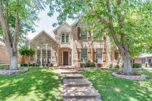 8017 Stonehill Dr, Plano, TX 75025 - view of front facade featuring brick siding, a front lawn, and stone siding