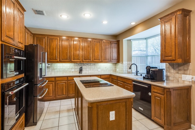 8017 Stonehill Dr, Plano, TX 75025 - kitchen with black appliances, a sink, brown cabinetry, light countertops, and tasteful backsplash