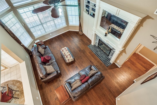 8017 Stonehill Dr, Plano, TX 75025 - living area with a fireplace with flush hearth, hardwood / wood-style flooring, a ceiling fan, and baseboards