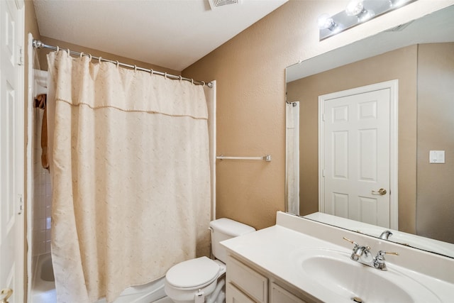 8017 Stonehill Dr, Plano, TX 75025 - bathroom featuring vanity, toilet, a textured wall, and shower / bathtub combination with curtain