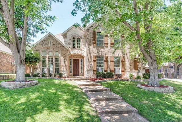 8017 Stonehill Dr, Plano, TX 75025 - view of front of property with brick siding, a front yard, and stone siding