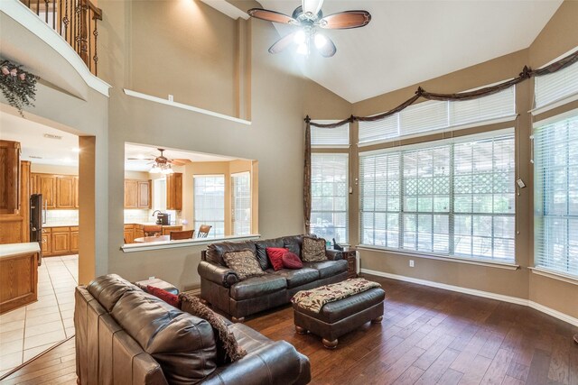 8017 Stonehill Dr, Plano, TX 75025 - living room with ceiling fan, light wood-type flooring, a towering ceiling, and baseboards