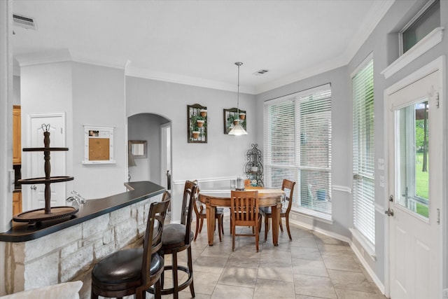 12319 N Emerald Ranch Ln, Forney, TX 75126 - dining area featuring crown molding, plenty of natural light, arched walkways, and bar area