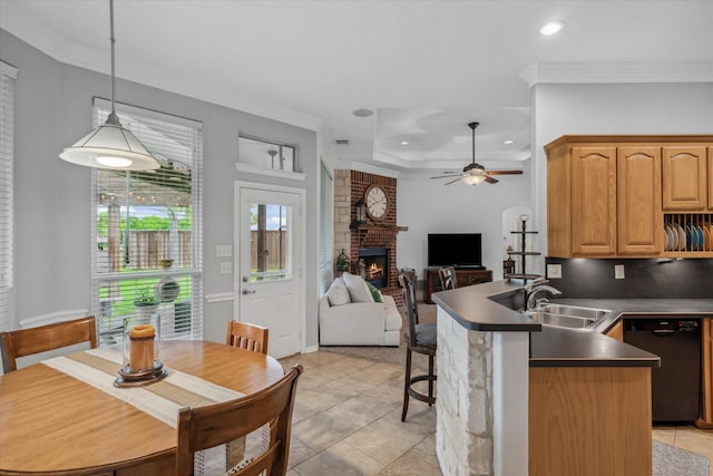 12319 N Emerald Ranch Ln, Forney, TX 75126 - kitchen featuring black dishwasher, dark countertops, a brick fireplace, a peninsula, and ceiling fan
