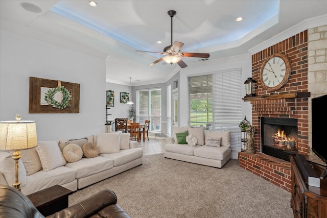 12319 N Emerald Ranch Ln, Forney, TX 75126 - carpeted living room with crown molding, a ceiling fan, a fireplace, a raised ceiling, and recessed lighting