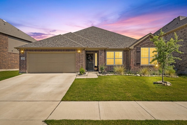 952 Sweeping Butte Dr, Fort Worth, TX 76052 - view of front of house featuring a garage, roof with shingles, concrete driveway, brick siding, and a yard