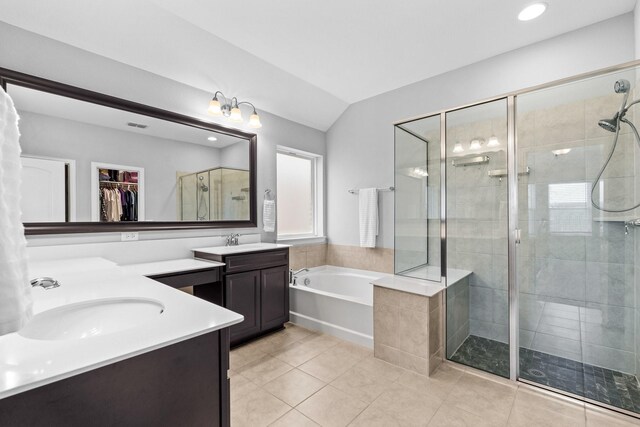 952 Sweeping Butte Dr, Fort Worth, TX 76052 - bathroom featuring double vanity, a bath, a stall shower, tile patterned floors, and a walk in closet