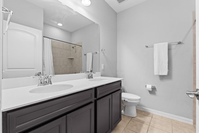 952 Sweeping Butte Dr, Fort Worth, TX 76052 - bathroom featuring toilet, double vanity, a tile shower, tile patterned floors, and baseboards