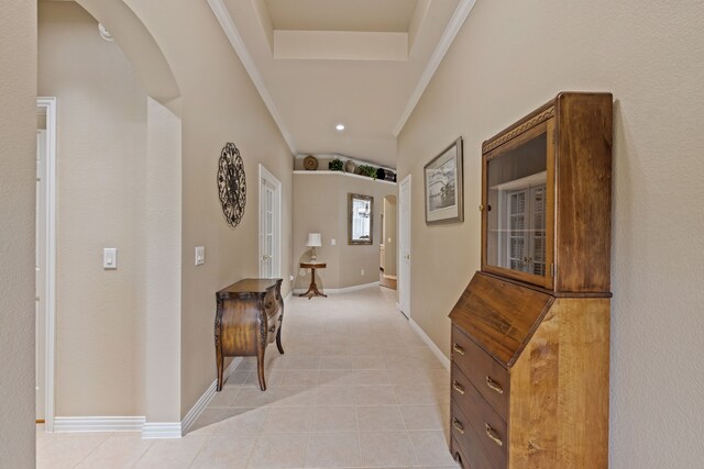 936 Medinah Dr, Fairview, TX 75069 - hall with light tile patterned floors, arched walkways, baseboards, crown molding, and a tray ceiling
